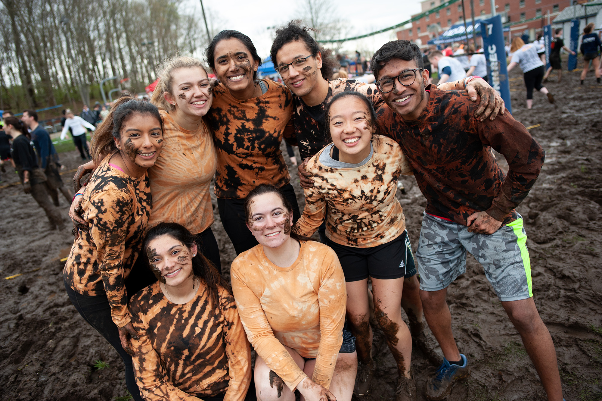 Students in orange pose during oozeball tournament